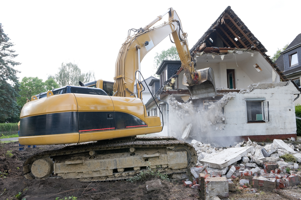A,Digger,Demolishing,Houses,For,Reconstruction.